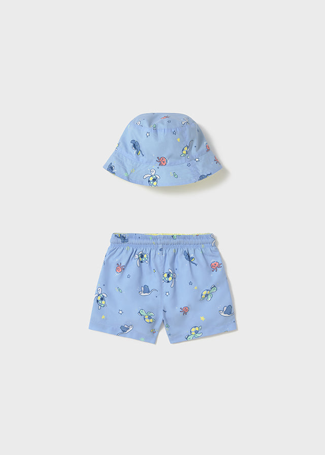 Sett med badeshorts og solhatt blå